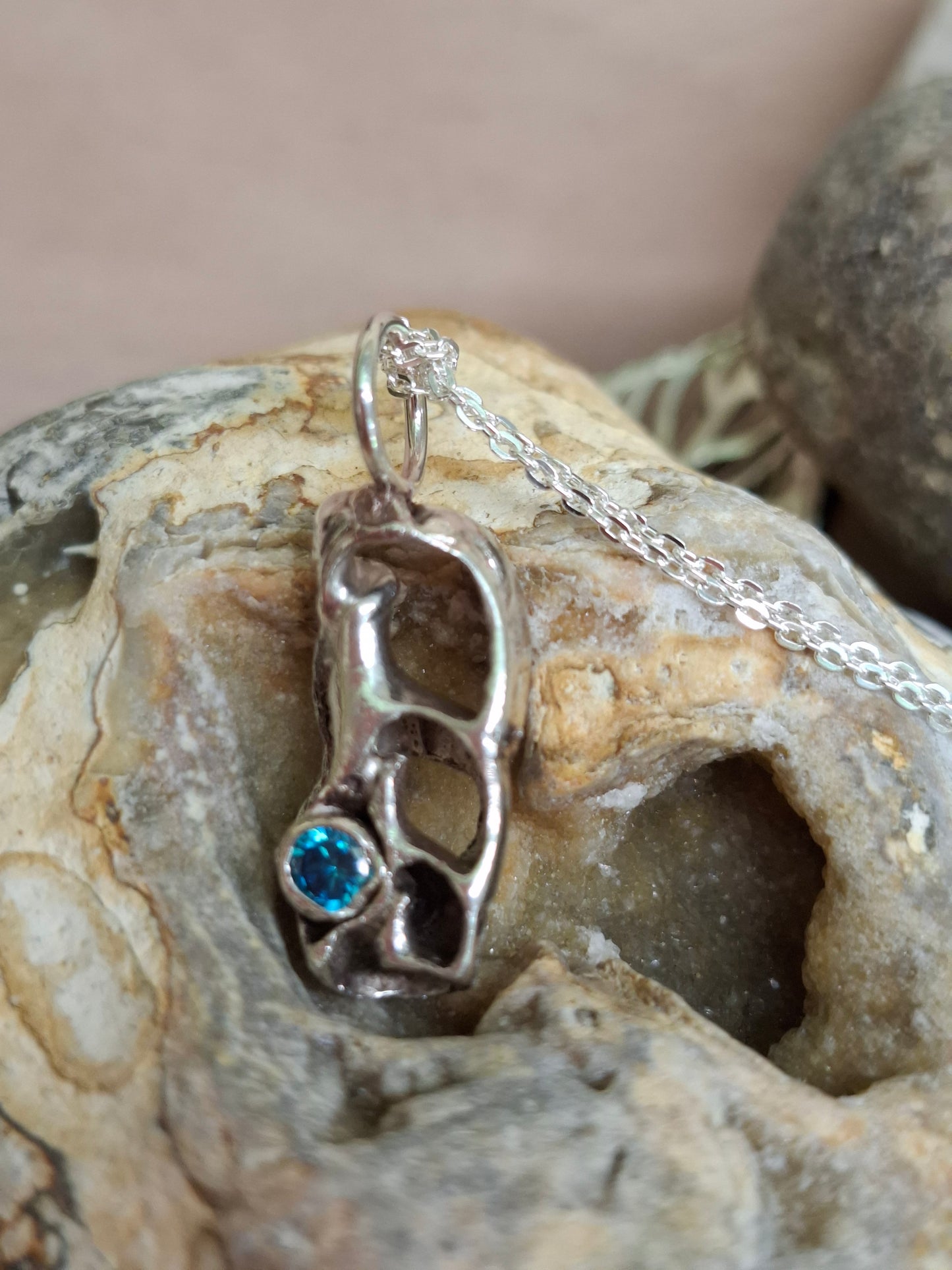 Cast silver seashell with aquamarine cubic zirconia