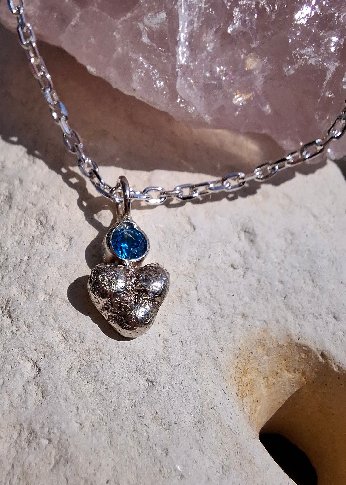 Dinky silver pebble heart and sparkly aquamarine cubic zirconia