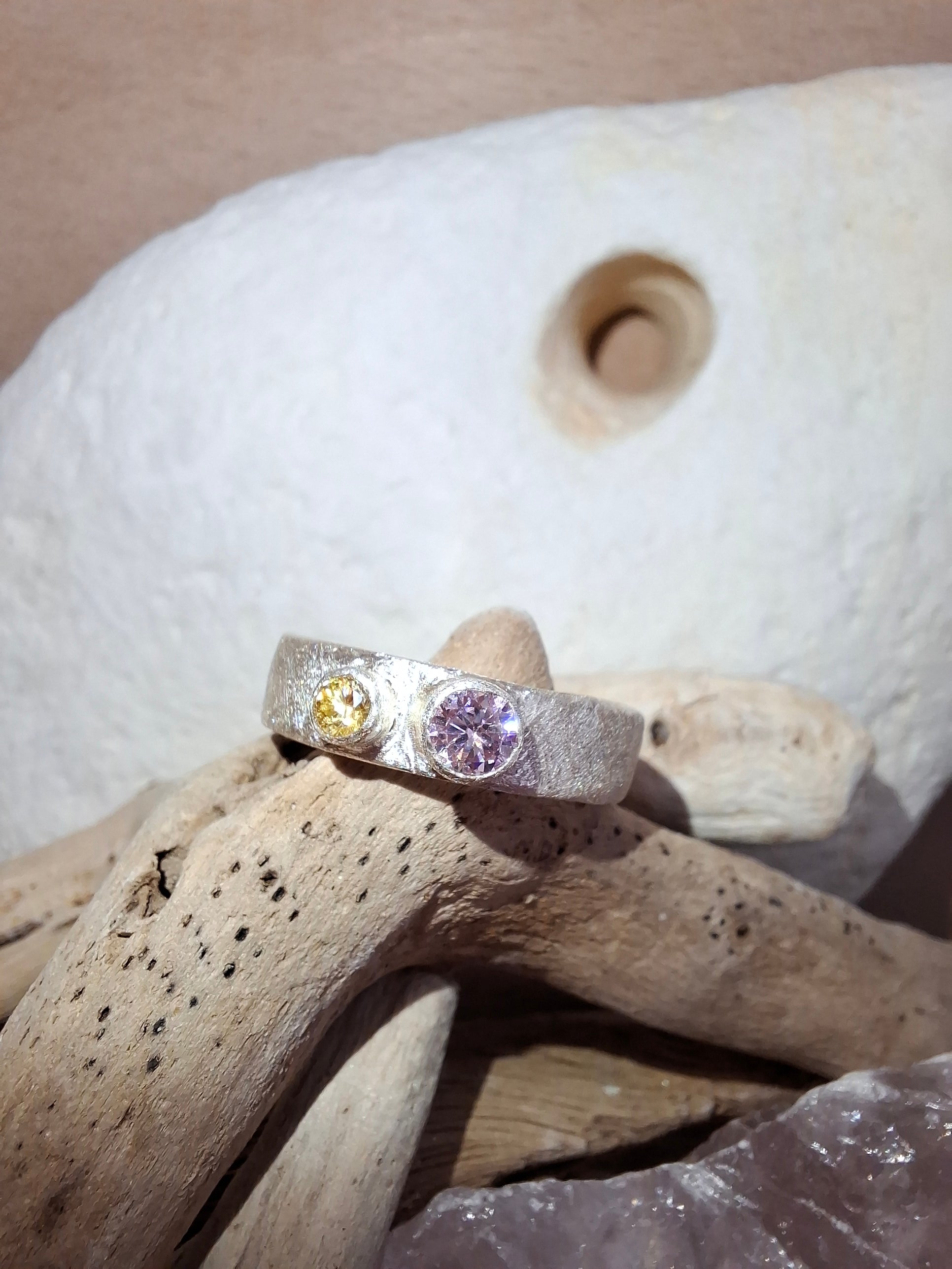 Textured silver ring with rose pink and yellow cubic zirconias.