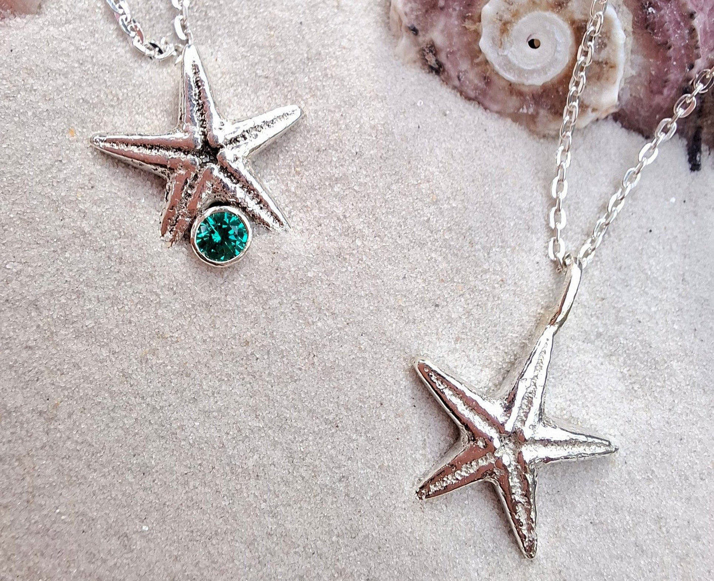 Cast silver starfish pendant with a teal green cubic zirconia, with necklace