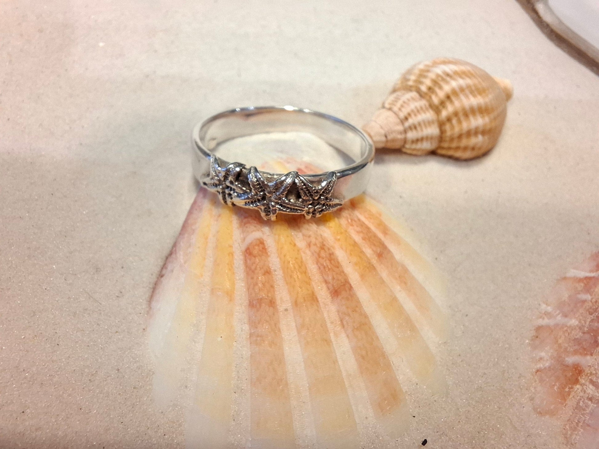 Silver ring featuring delicate silver starfish