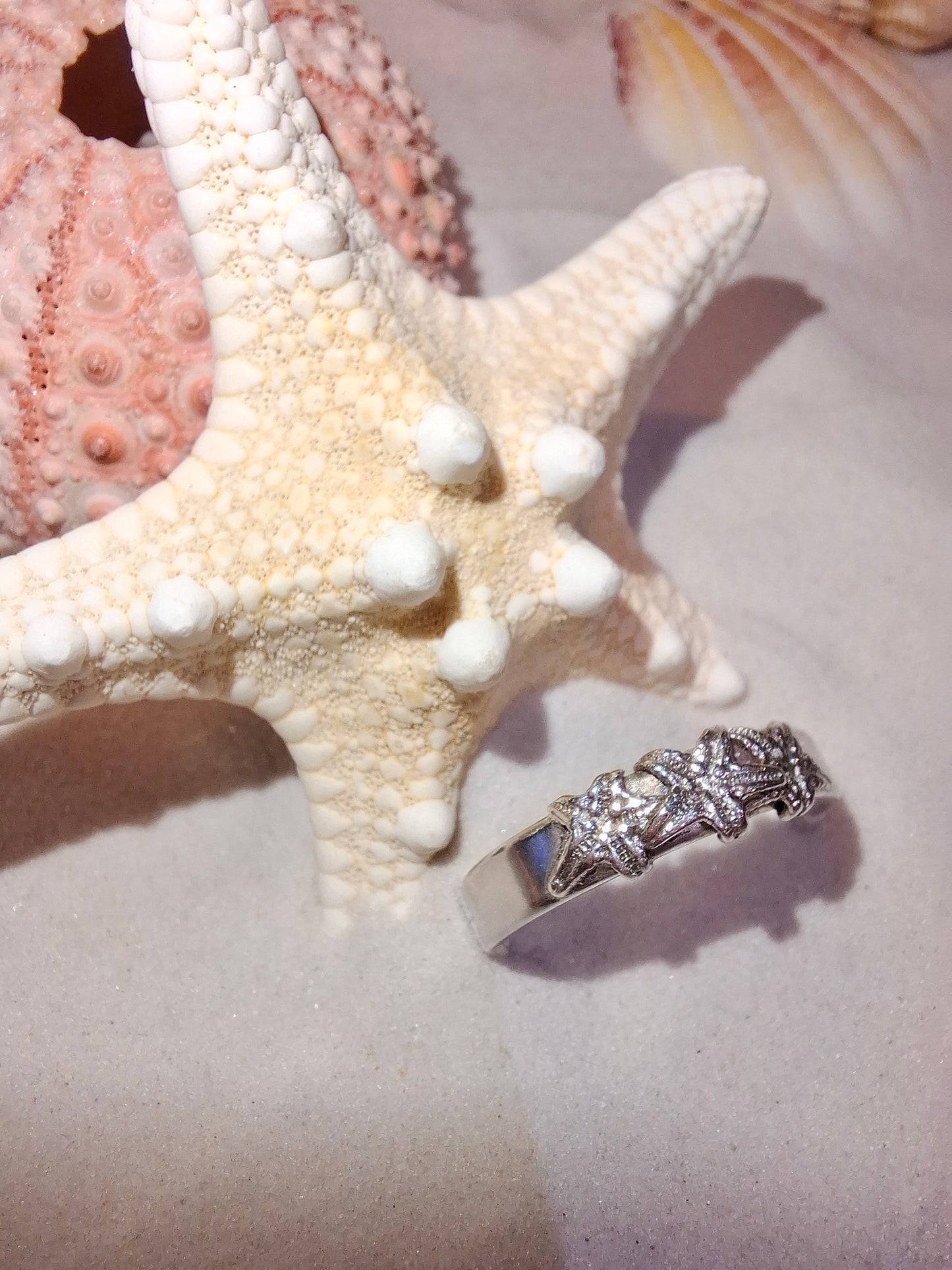 Silver ring featuring delicate silver starfish