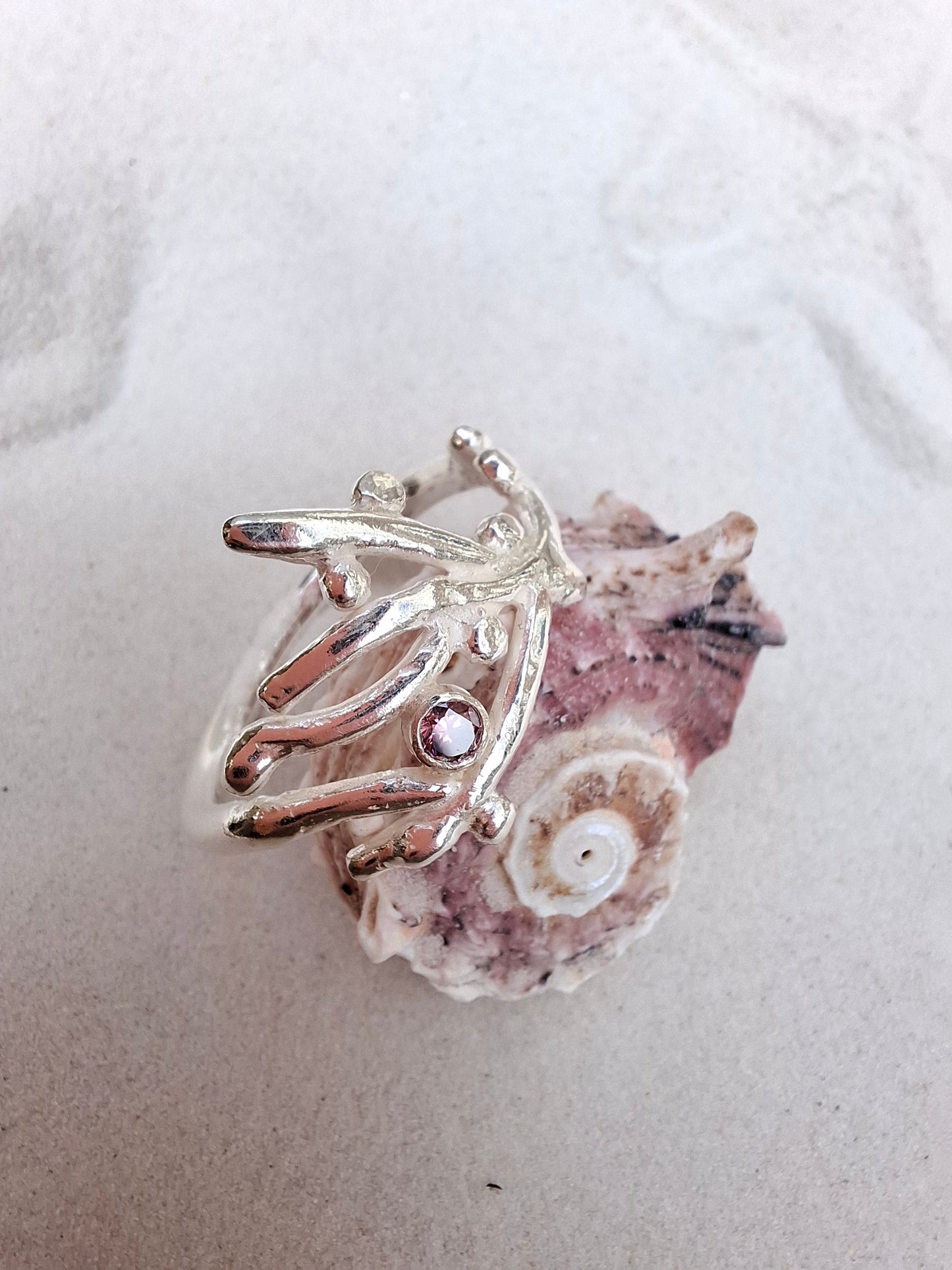 Coral inspired silver ring with a rhodolite pink cubic zirconia