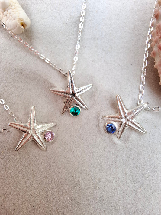 Cast silver starfish pendant with a vibrant cubic zirconia, with necklace