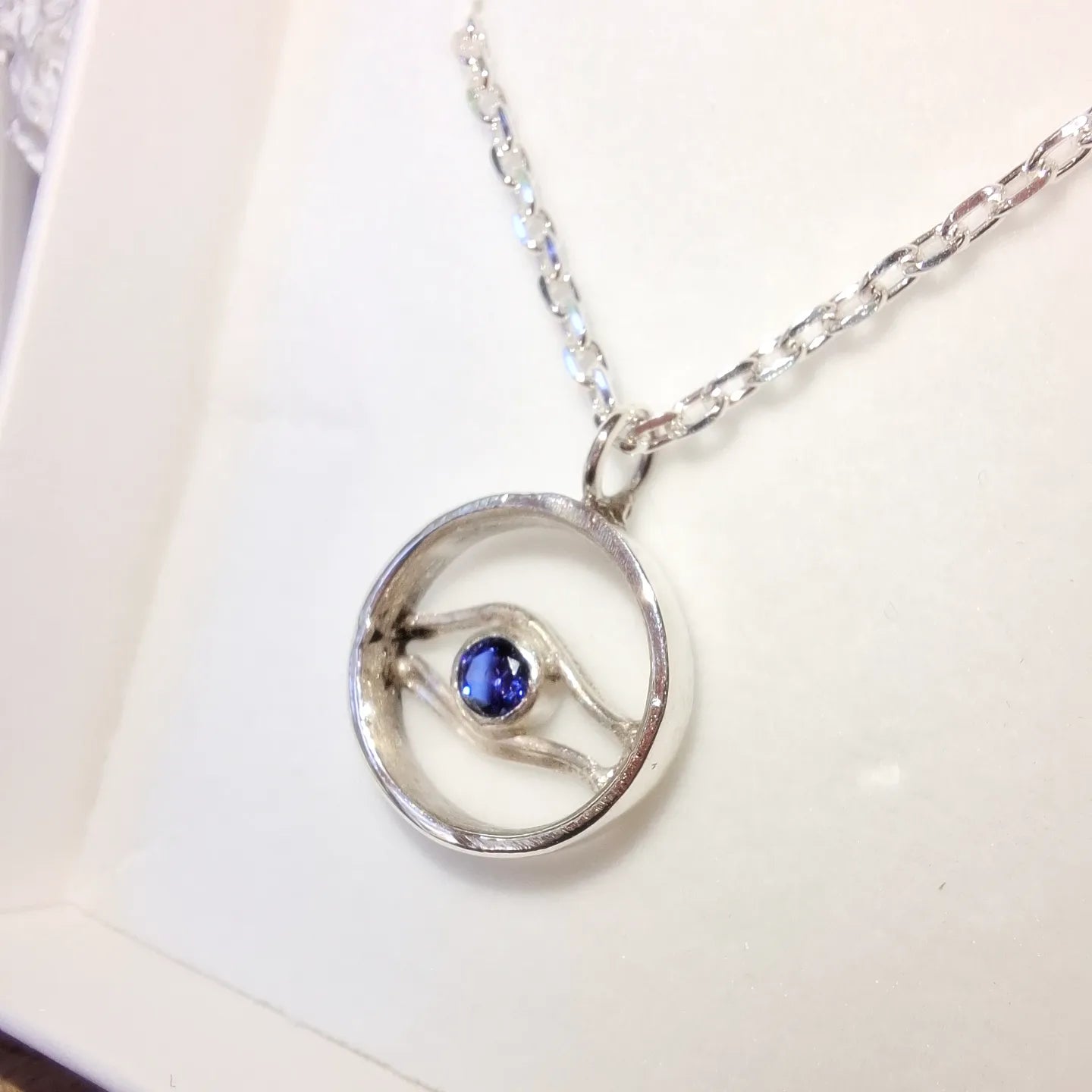 Silver and Tanzanite Cubic Zirconia Wave and Evil Eye Circle inspired Pendant